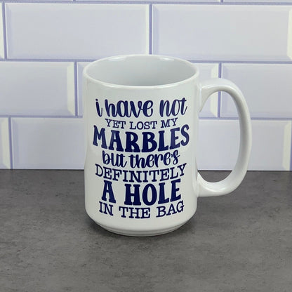 Have not lost marbles yet/hole in bag mug